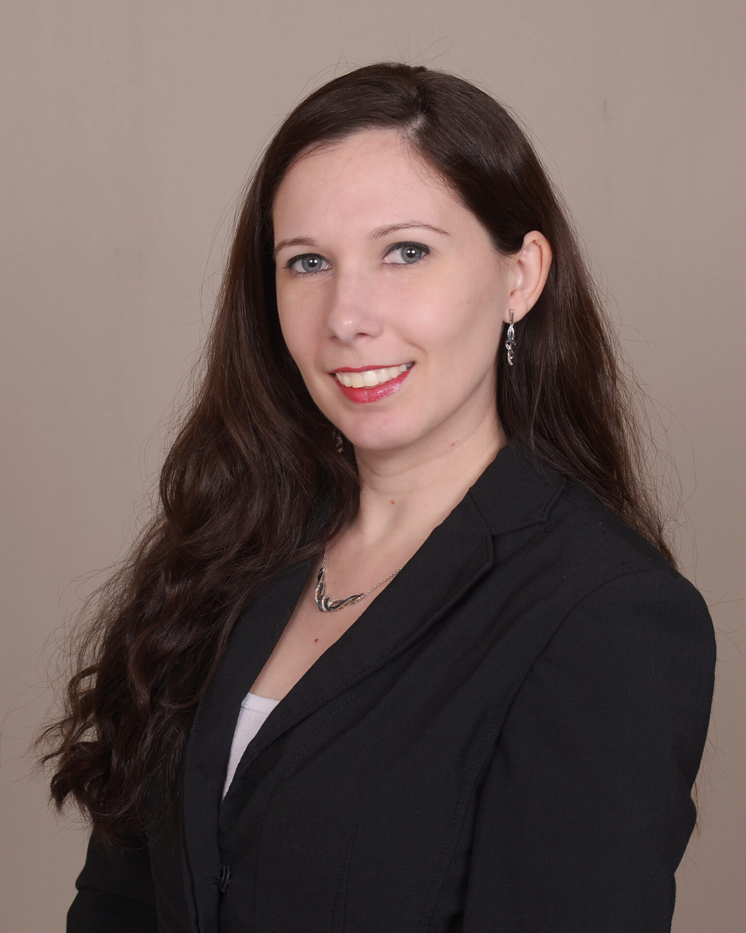 A woman in black jacket and white shirt.