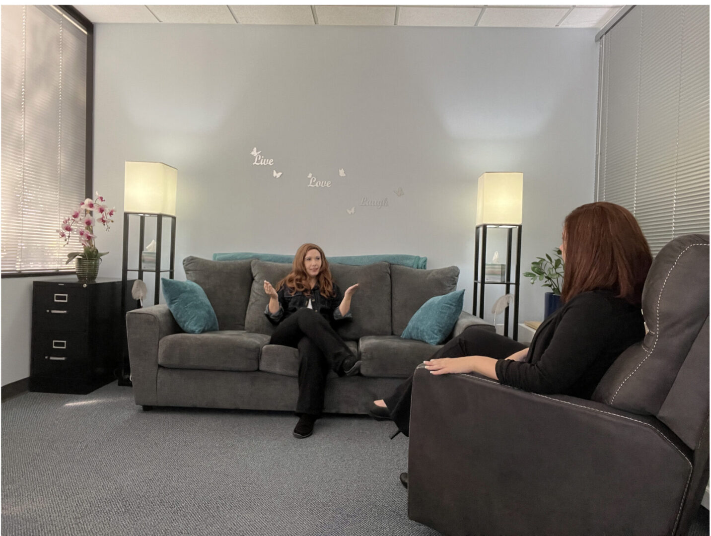 Two women engaged in a conversation in a cozy office setting.